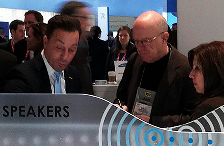 Grand Communciations’ Laura Liebeck and Coby Electronics’ Michael Paladino give a reporter a walk-through of the company’s new product line-up at the 2013 Consumer Electronics Show