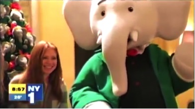 Grand Communications’ Nancy Kaplan with the world’s most famous elephant, Babar, on a NY1 “Parenting Report” showcasing festive “Tea Time With Babar” events for families at Hôtel Plaza Athénée