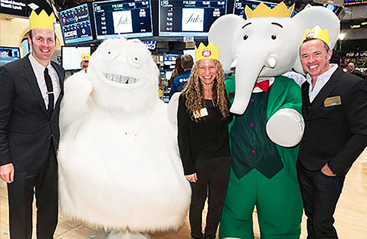 Grand Communications’ Alison Grand and Nelvana Enterprises’ Colin Bohm (left) and Andrew Kerr don festive crowns to celebrate the 80th birthday of the world’s most famous elephant, Babar, along with Saks’ legendary Yeti just after ringing the Closing Bell at the New York Stock Exchange